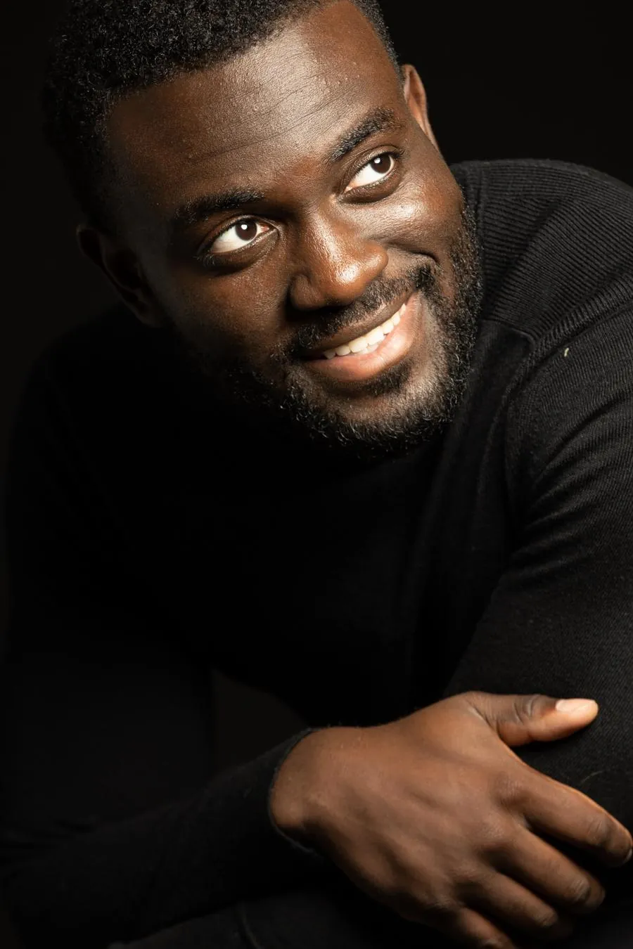 Portrait of Dr. Kojo in a black turtleneck