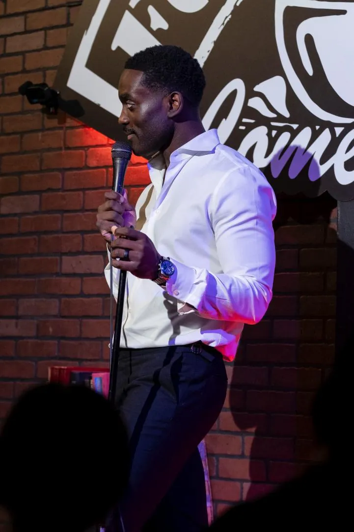 Dr. Kojo performing in a white shirt